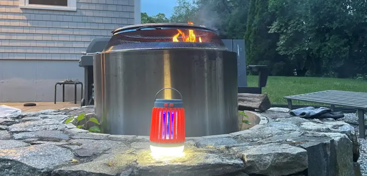 Bug zapper in front of a baker at a backyard.